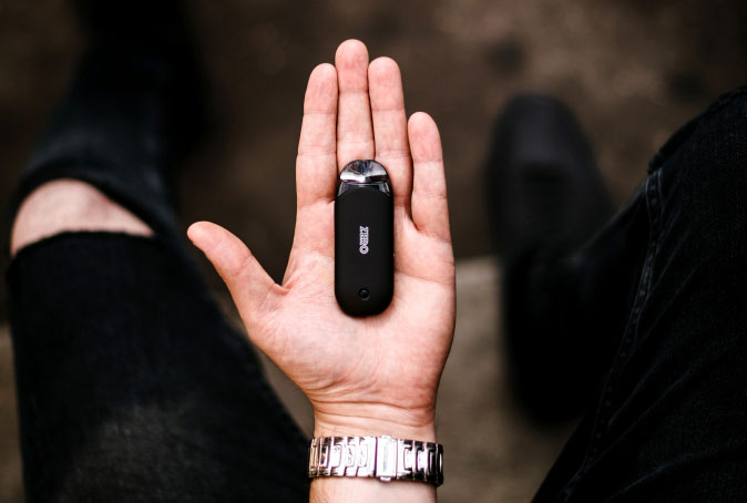Person Holding Black Vape in Palm of Hand 1 Person Holding Black Vape in Palm of Hand 1
